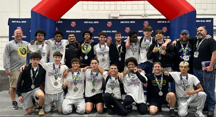 Olympic Heights wrestlers and coaches wearing medals at the 2026 AAU Scholastic Duals