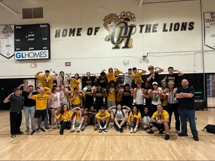 Olympic Heights wrestlers and coaches together in their home gym at the 2025 Juggernaut Tournament